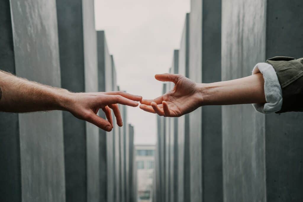 hands reaching out stock image