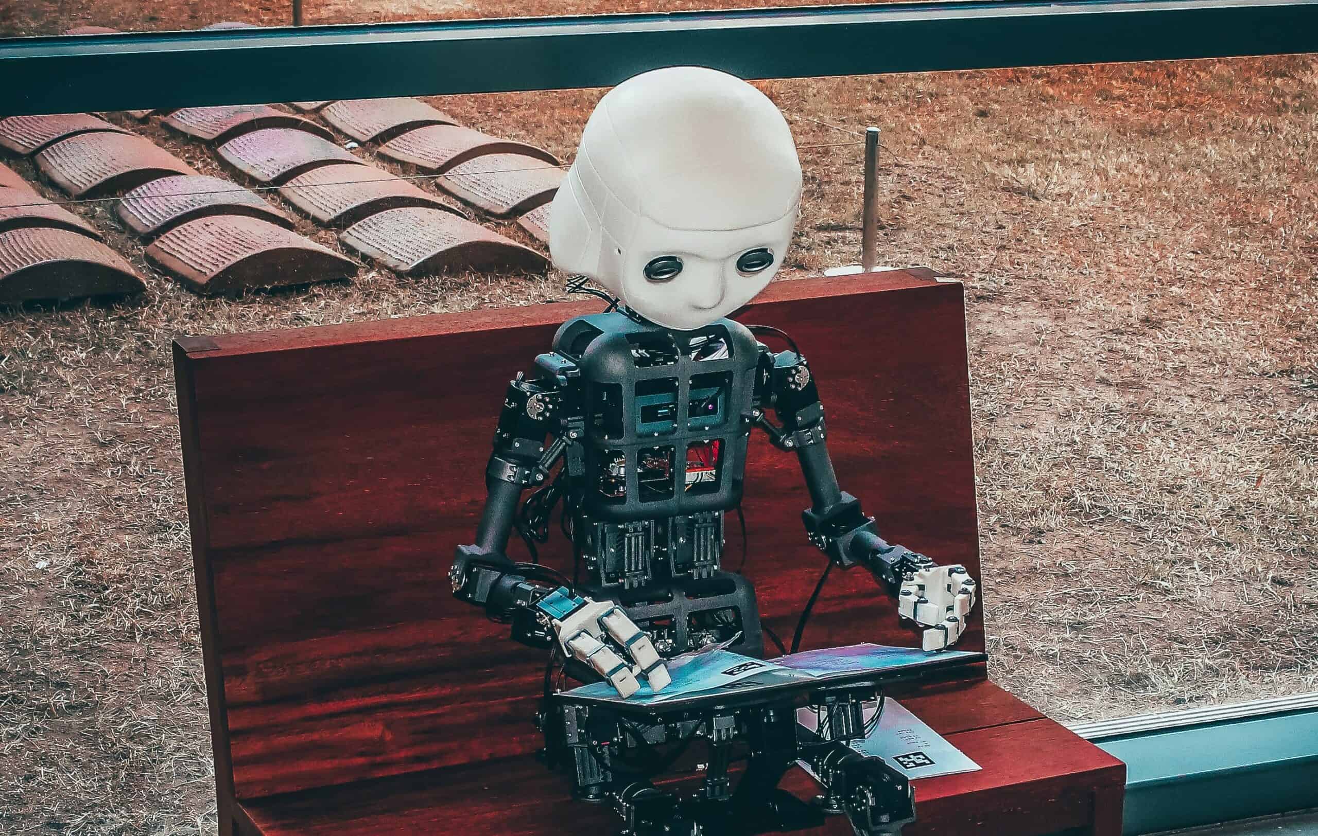 Robot reading on a bench